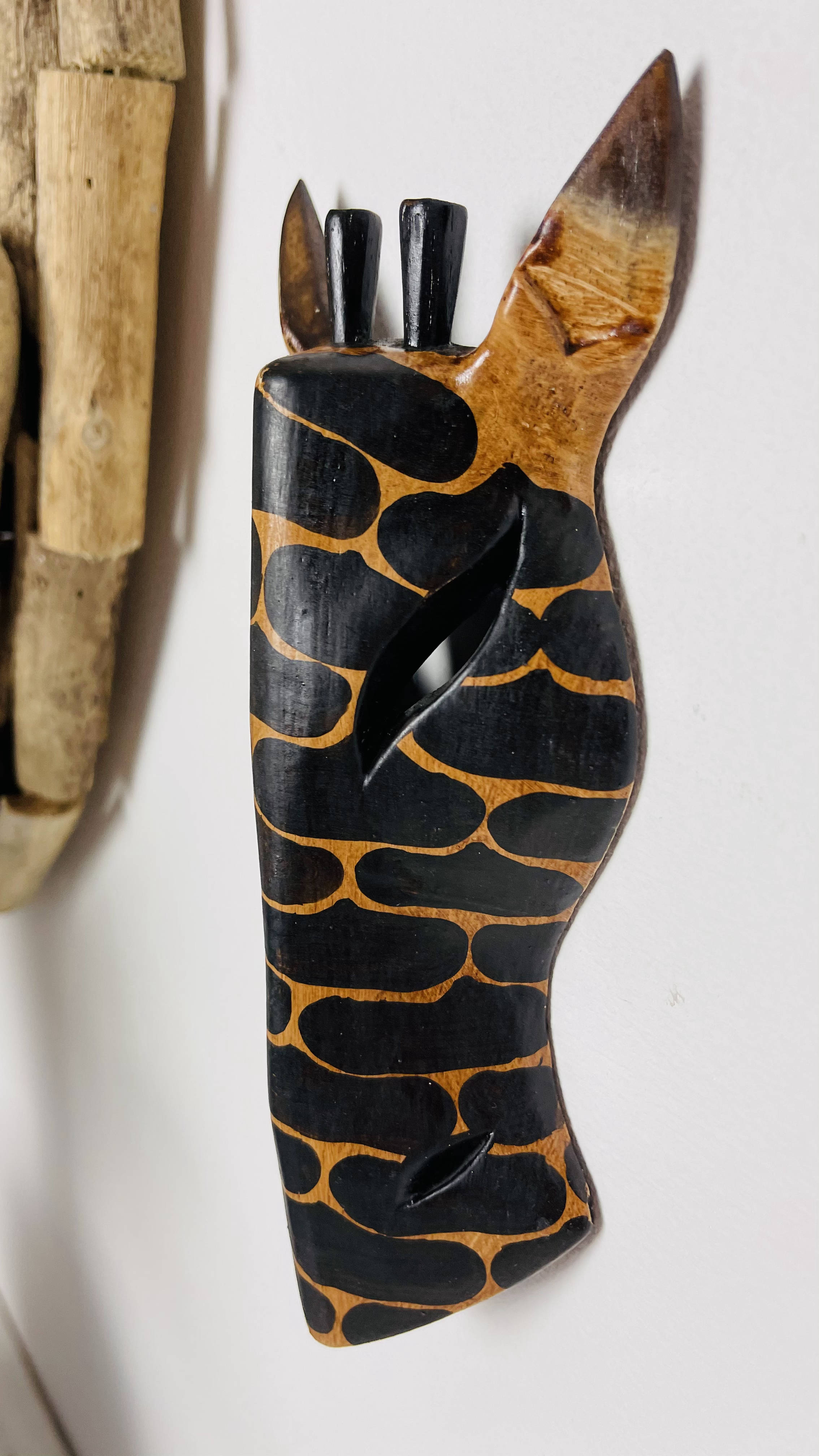 side view of wood giraffe mask