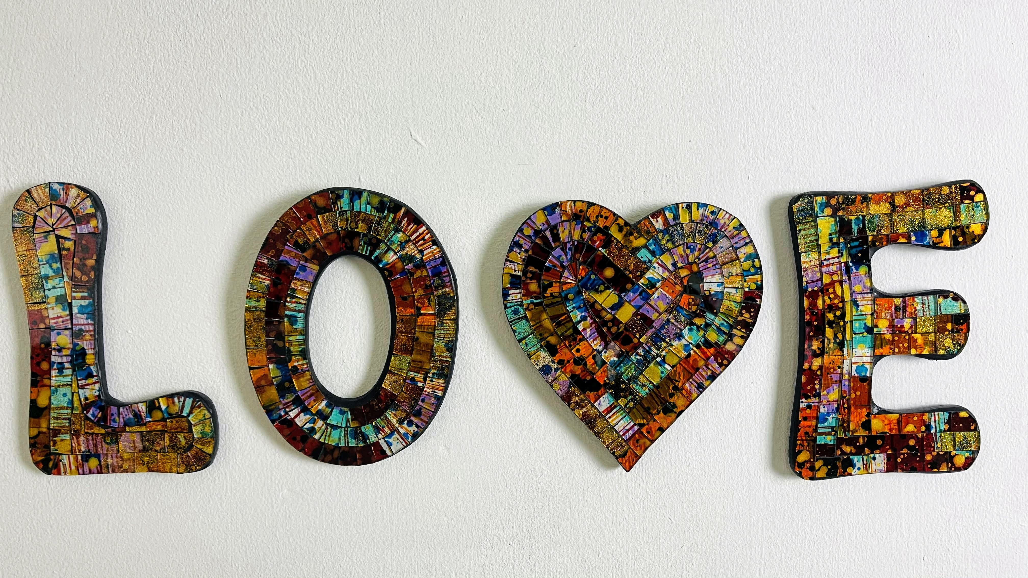 front view of mosaic love letters hung individually