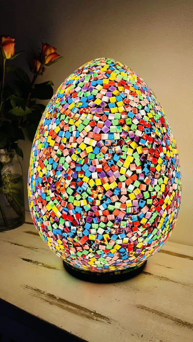 side view of mosaic egg lamp with light on