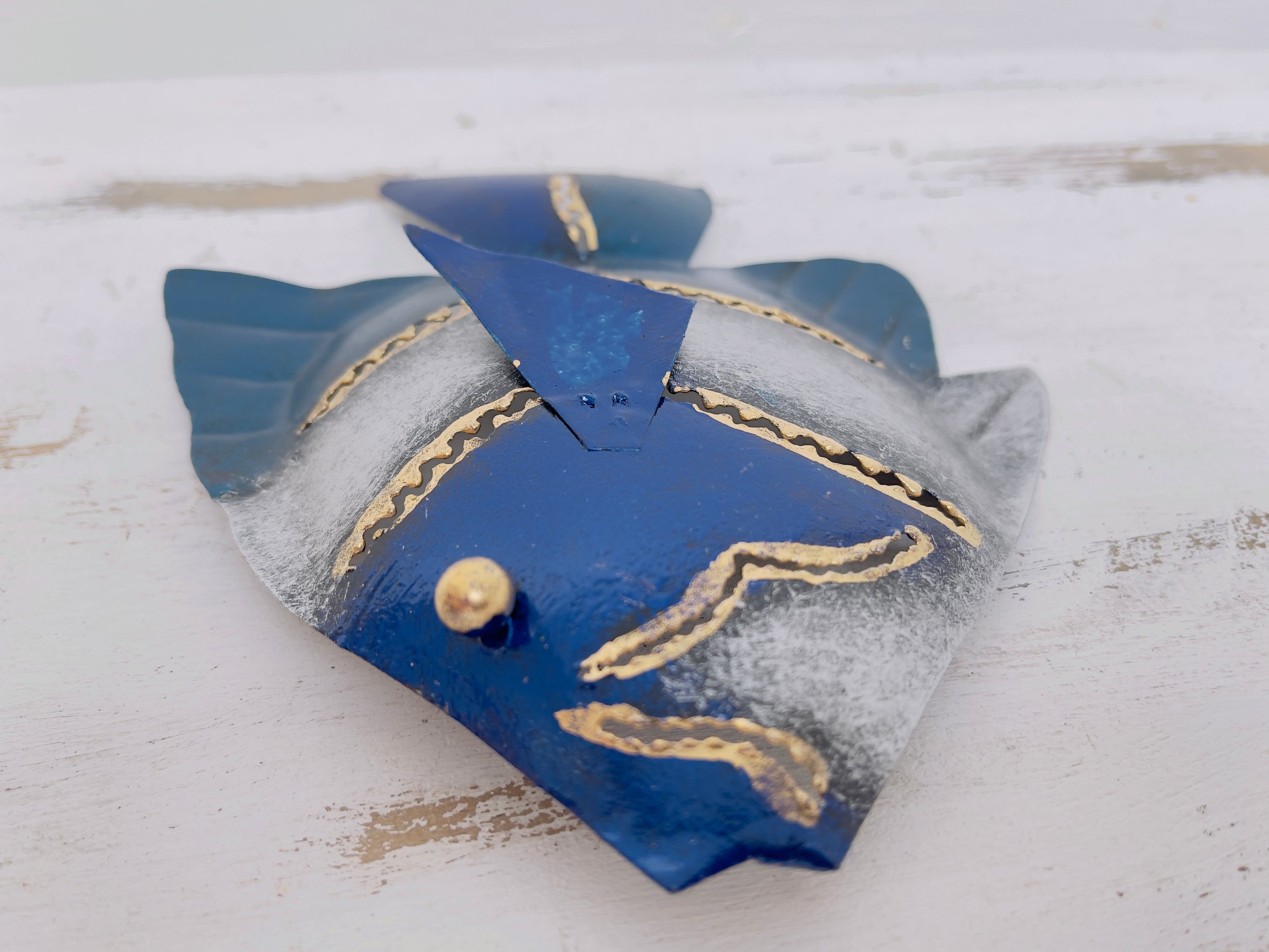close up of metal banner fish in blue
