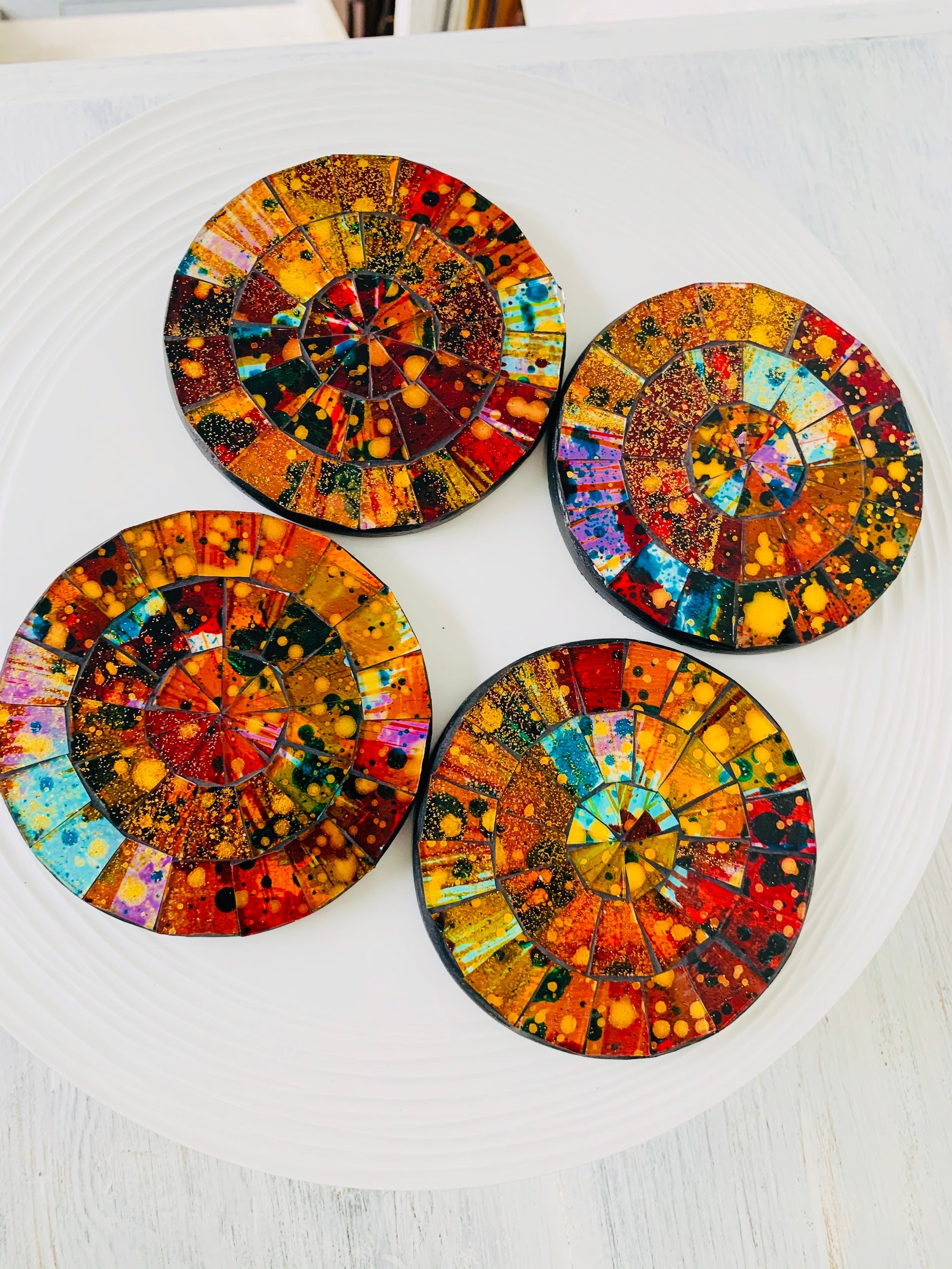 aerial view set of round mosaic coasters on white background