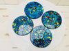 aerial view of set of mosaic coasters in blue on white background