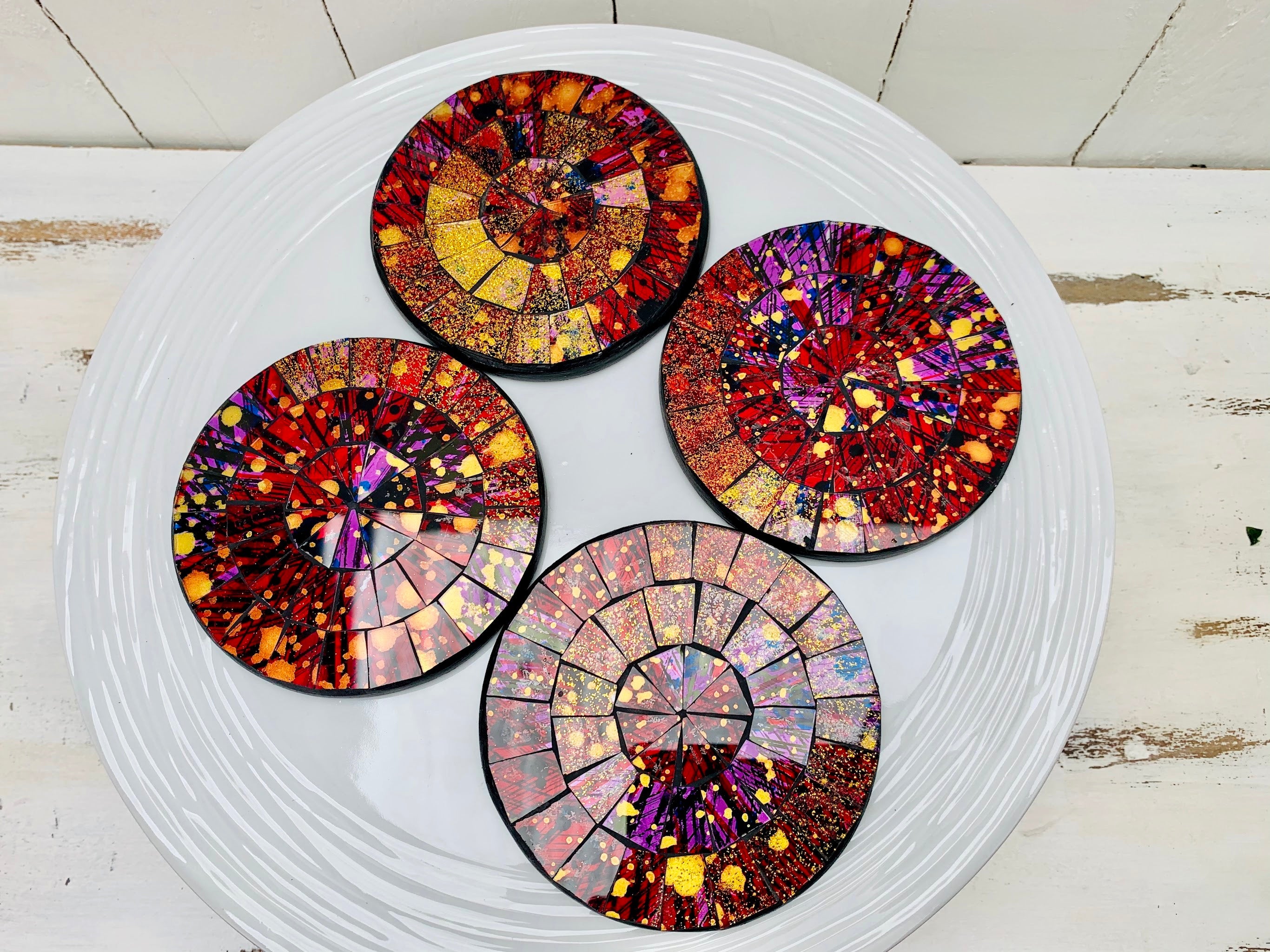 aerial view set of four mosaic coasters on white surface