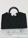 front view of black beaded bag on white background