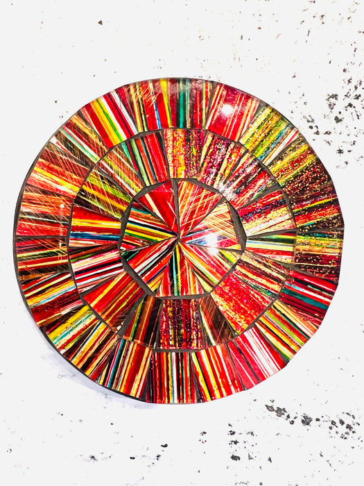 Hand-painted Electric mosaic coaster with bold red, yellow and orange glass pieces on MDF base, photographed from above on a light textured surface.
