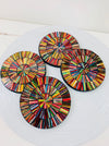 Electric-style mosaic coasters arranged together, showing vivid multicolour hand-painted glass designs on a white background.