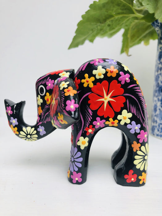 side view of black wooden flower elephant