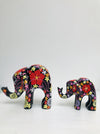 side view of small and large wooden elephants