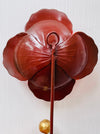 Back view of handmade red hibiscus metal wall hook.