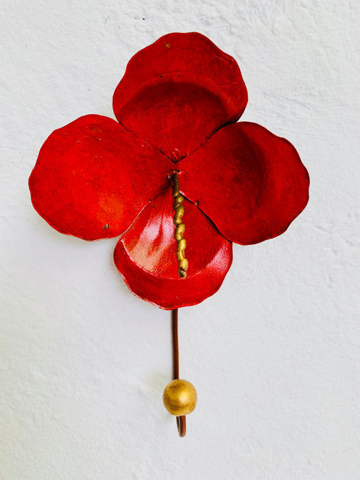 Handmade red hibiscus flower wall hook with gold detailing.