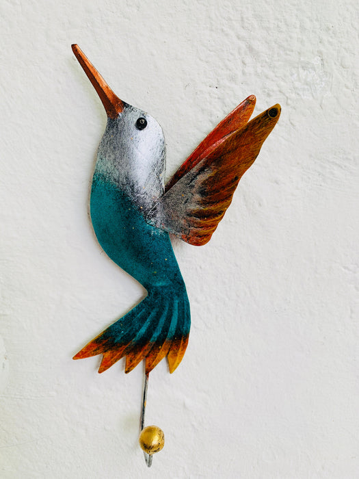 Handmade green humming bird hook with silver and rust detailing.