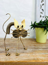 front view of metal scaredy cat on wooden surface