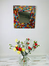 front view display of mosaic mirror with a vase of flowers