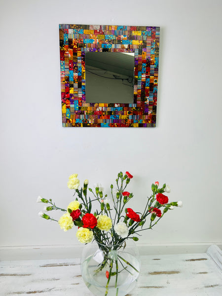 front view display of mosaic mirror with a vase of flowers