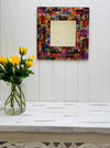 display front view of mosaic square mirror with a vase of flowers below as decoration