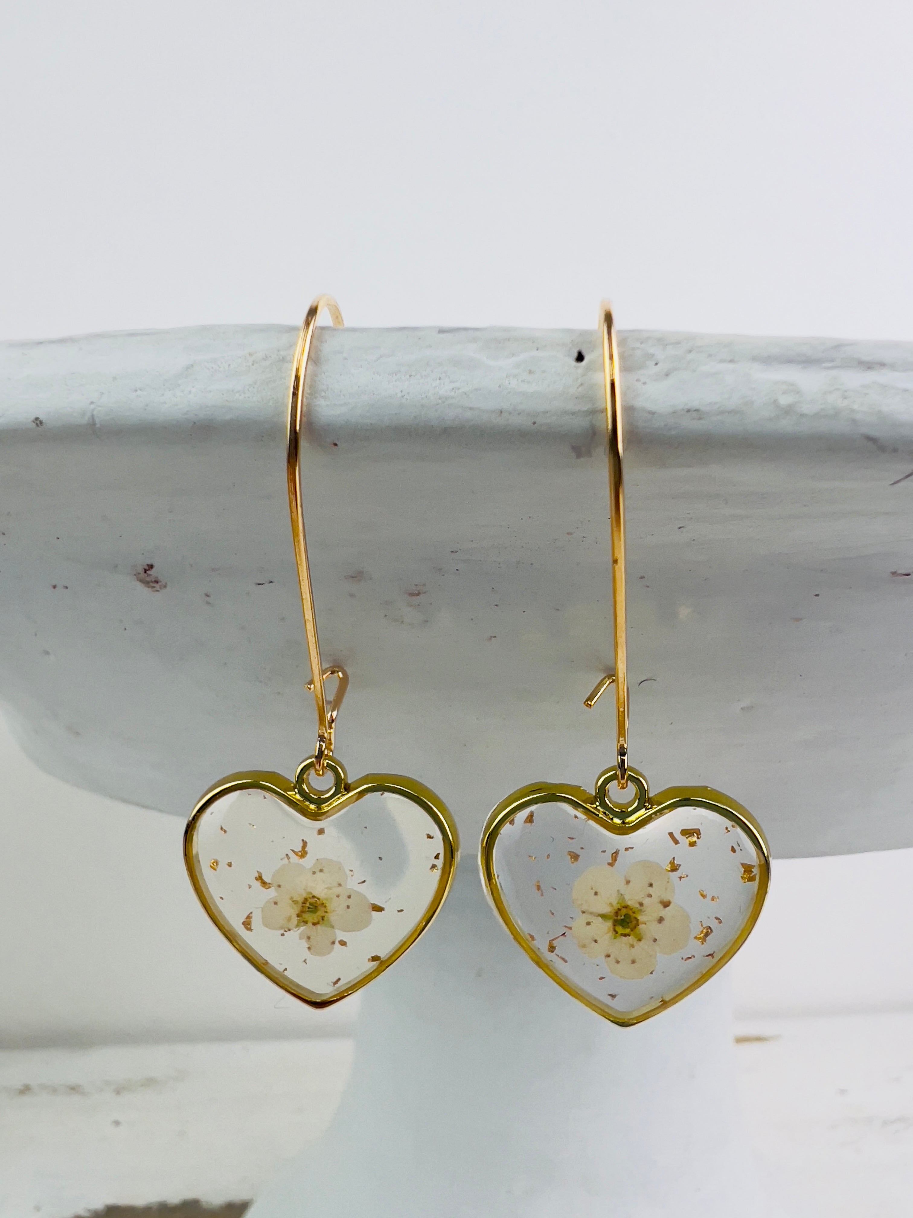 front view of pair of heart shaped earrings