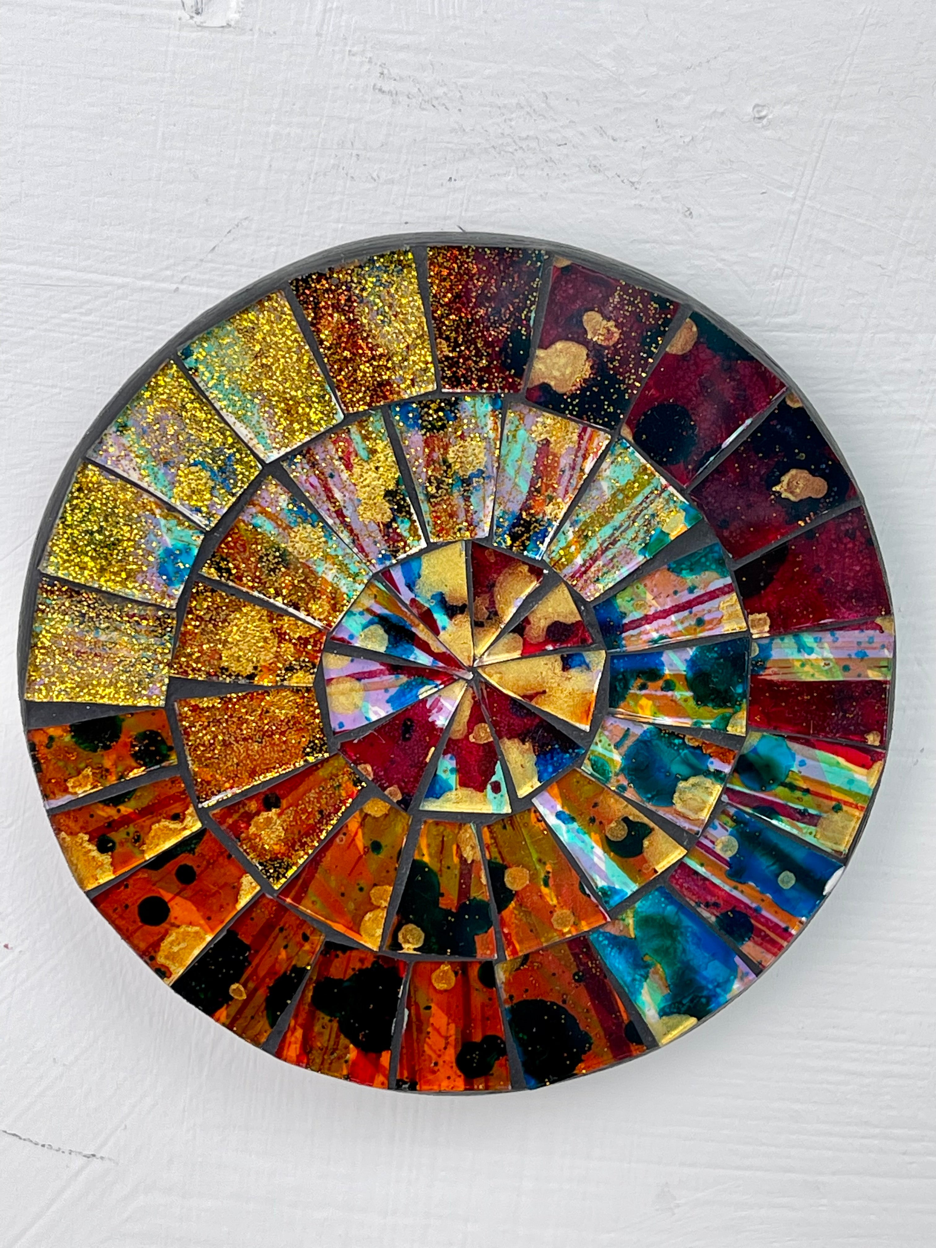 aerial view of round mosaic coaster on white background