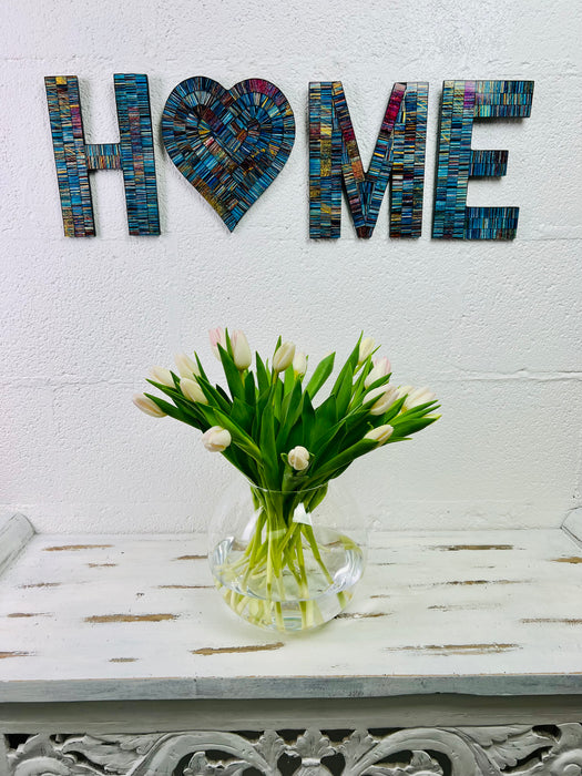 display view of mosaic wall art home on wall with vase of flowers below