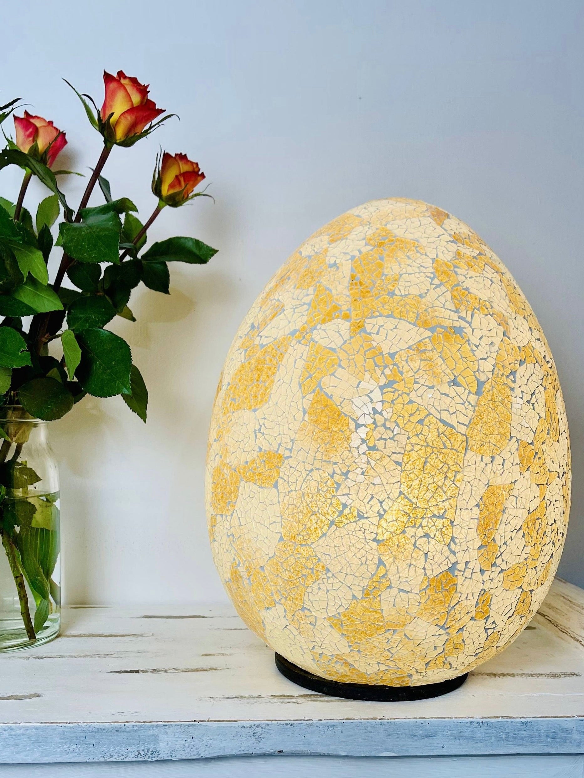 front view of mosaic egg lamp with light on