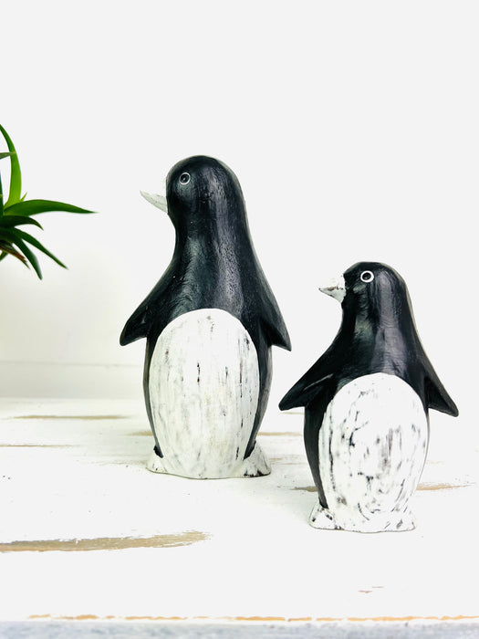 front view of small and large wood penguins