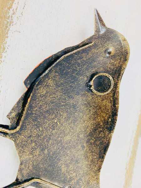 close up of back of robin with hook attached