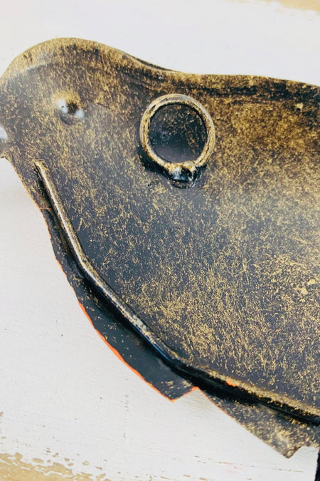 close up of back of robin with hook attached