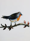 front view of hand-painted metal robin perched on a branch wall decoration
