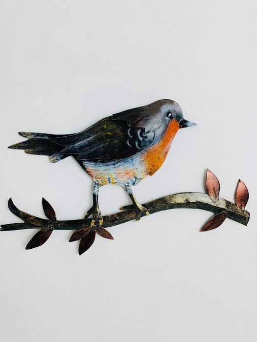 front view of hand-painted metal robin perched on a branch wall decoration
