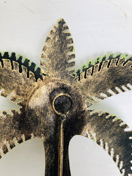 close up back view of metal palm tree hook