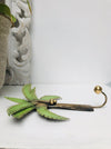 side view of metal palm tree hook