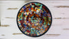 Top view of handmade mosaic glass bowl in Calypso multicolour tones showing red, orange, yellow and green circular pattern.