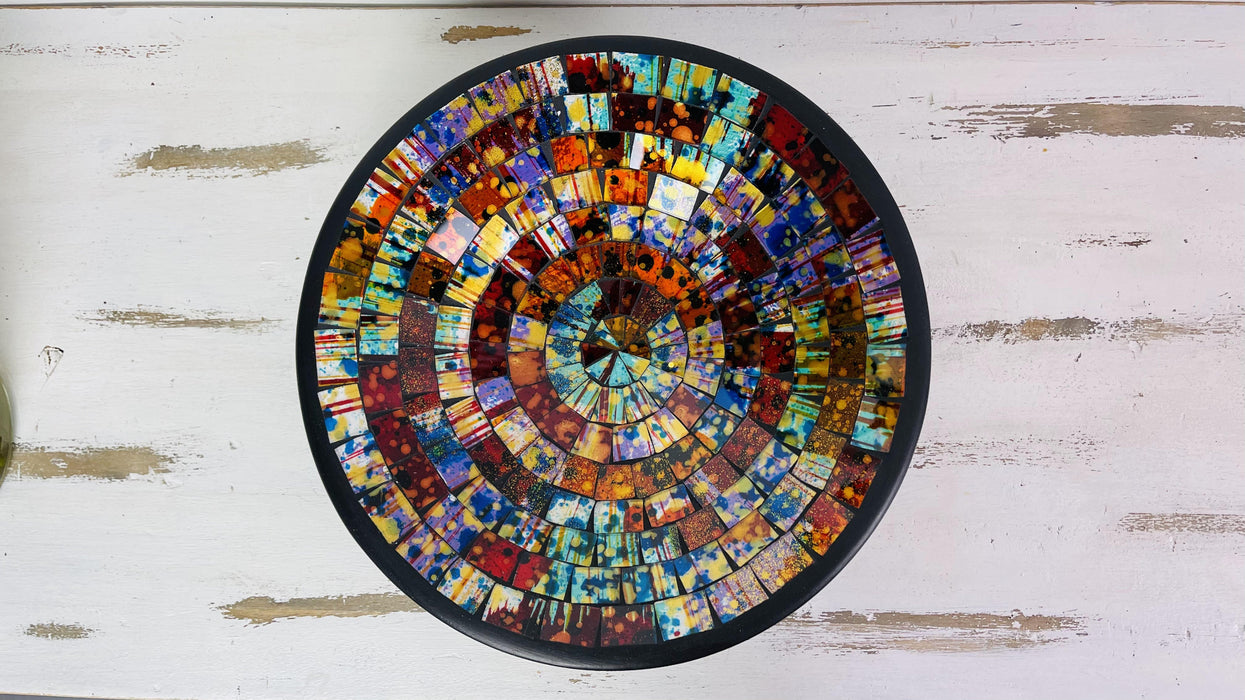 Top view of handmade mosaic glass bowl in Calypso multicolour tones showing red, orange, yellow and green circular pattern.