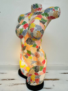 side view of mosaic bust lamp with light on