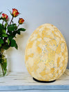 front view of mosaic egg lamp with light on