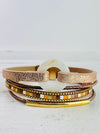 A gold multi-strand bracelet with a mix of textures and a magnetic closure
