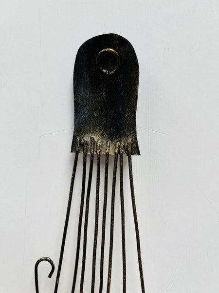 Back of blue octopus metal wall art showing hanging eyelet and metal shaping