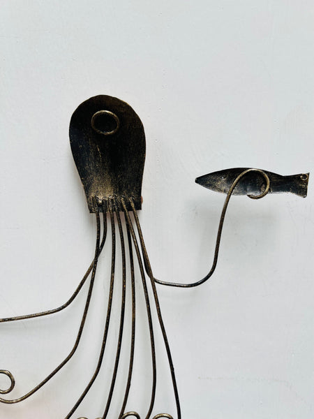 Back of copper octopus metal wall art showing hanging eyelet and metal structure