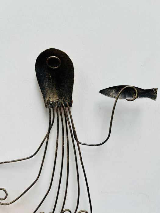 Back of copper octopus metal wall art showing hanging eyelet and metal structure