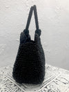 side view of black beaded handbag