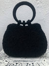 front view of beaded black handbag