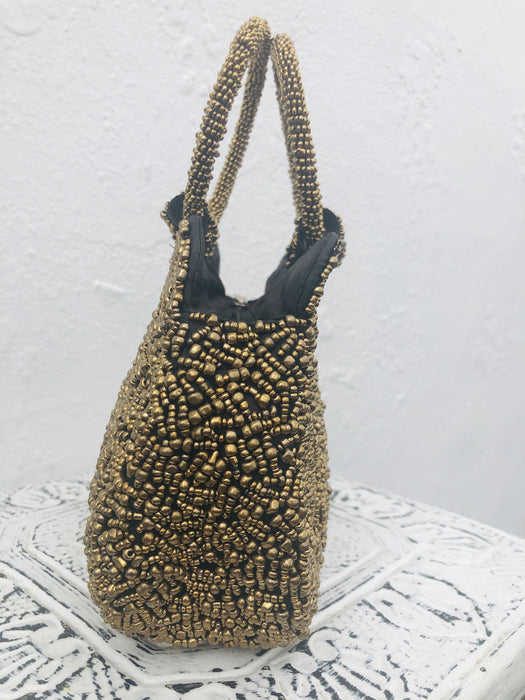 side view of gold beaded handbag