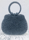 front view of beaded blue handbag