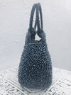 side view of blue beaded handbag