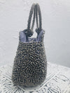 side view of silver beaded handbag