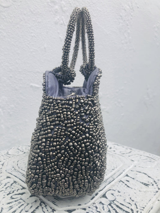 side view of silver beaded handbag