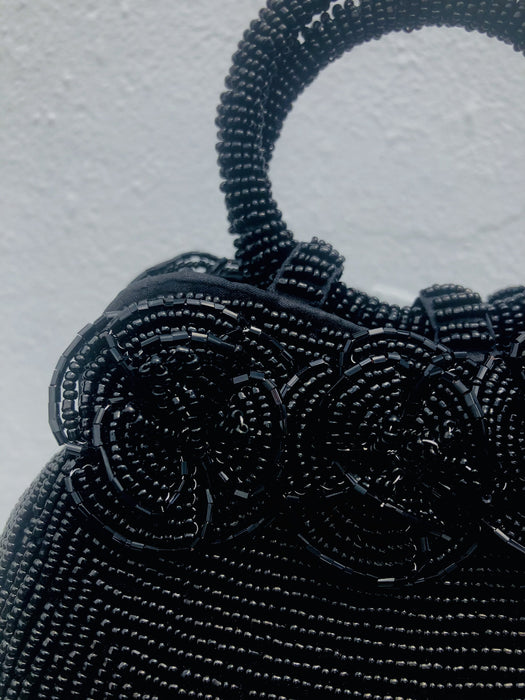 close up of rose beaded flowers on handbag