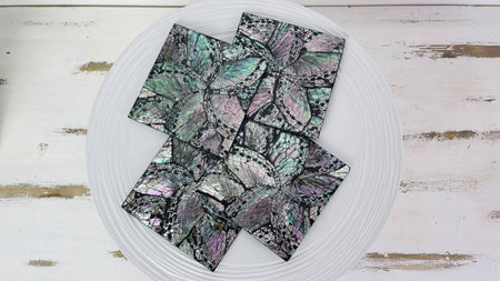 Set of black flower shell coasters showing cracked-shell pattern and glossy resin finish.