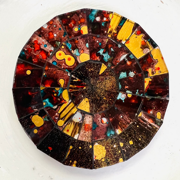 Close-up view of the Siena mosaic coaster showing detailed hand-painted glass pieces in warm earthy tones.