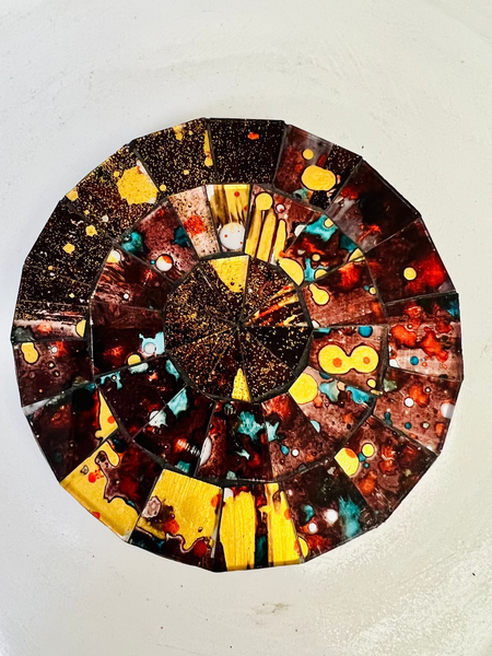 Hand-painted Siena mosaic coaster with warm brown, red and gold glass pieces on MDF base, photographed from above on a light surface.