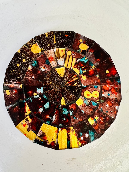 Hand-painted Siena mosaic coaster with warm brown, red and gold glass pieces on MDF base, photographed from above on a light surface.